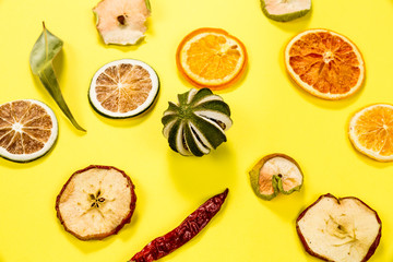 Colorful dried fruits isolated on yellow background