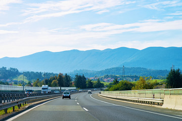 Scenic landscape with cars at road in Slovenia Julian Alps