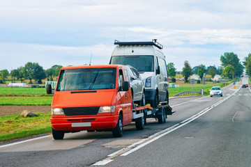 Car carrying trailer with mini vans on road of Slovenia