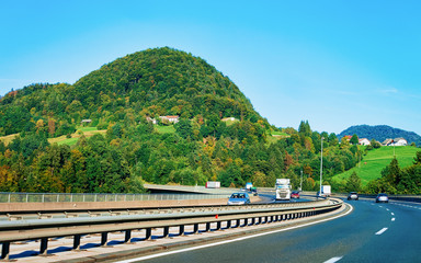 Scenic landscape and cars in road in Slovenia Julian Alps