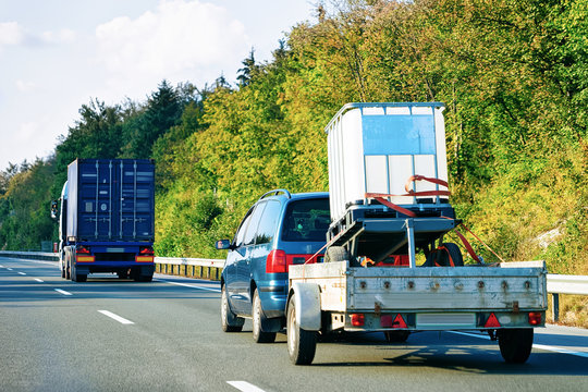 Car carrying trailer at asphalt road in Slovenia