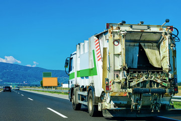 Truck carrying trailer with garbage container in Slovenia