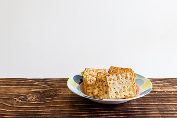 salty crackers on plate, white background