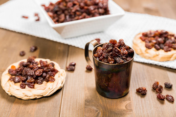 Organic dried raisins on a wooden background