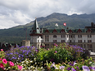 Colored flowers and historical building in european ST. MORITZ city center in Switzerland at alpine...