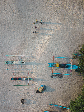 Overhead view of outriggers moored on beach