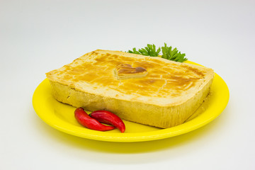 Heart pie with pepper on a yellow plate