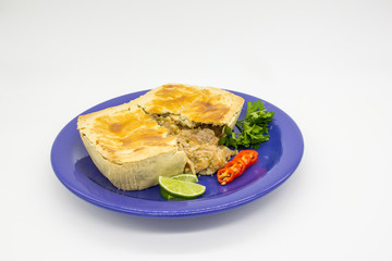 Big pie with lemon & parsley on a blue plate