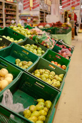 Bunch of red and green apples on boxes in supermarket