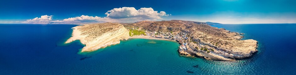 Aerial view of Matala beach on Crete island with azure clear water, Greece, Europe