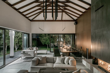 Illuminated interior with wooden beams and fireplace