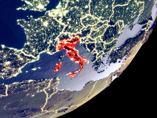 Italy from space on model of Earth at night. Very fine detail of the plastic planet surface and visible bright city lights.
