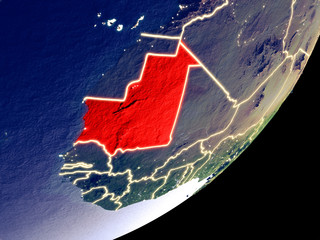 Mauritania from space on model of Earth at night. Very fine detail of the plastic planet surface and visible bright city lights.