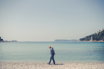 Tourist walking slowly on the beach