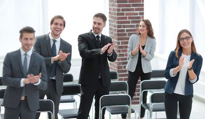 the team applauds the conference winner