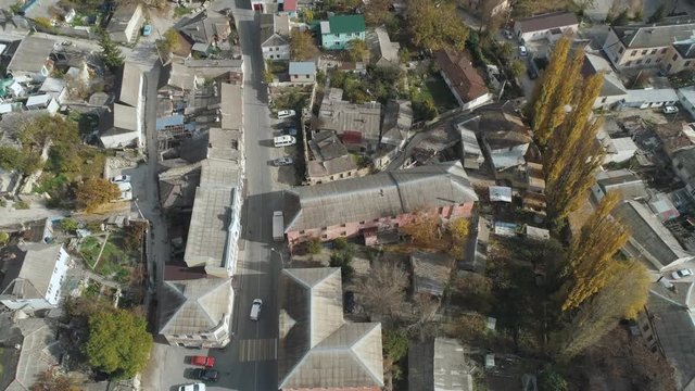 Aerial view of the city, houses and roads with trees. Shot. Urban landscape
