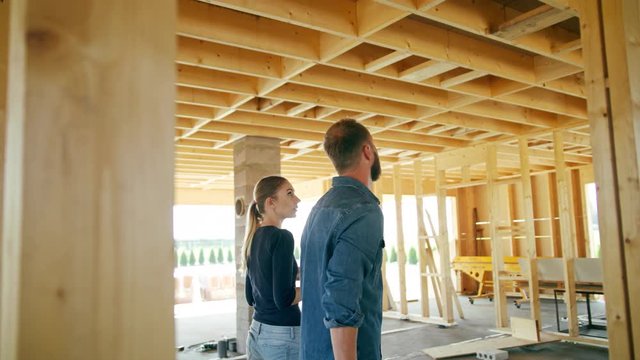 Two young people discussing the construction of a house inside the house. Medium shot. Soft focus