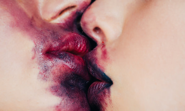 Lesbian kiss extremally closeup. Close up macro portrait of female part of  face. Human woman lips with beauty makeup. Girl with perfect plump lips.  Women's secrets. Love and sex. Dirty lips and