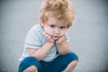 Fototapeta premium Thinking, thoughts, emotions. Adorable child. Children portrait. Capricious children. Depressed boy. Unsociable behaviour and lonely child. Think alone. Clever, thoughtful child.