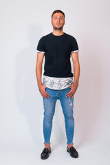 Obraz premium Full body shot of handsome bearded Persian man standing against white background