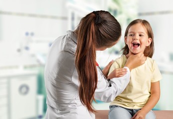 Young woman doctor with little girl  in a hospital
