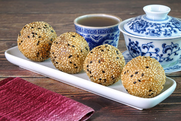 Dragon Pearl or Dradon balls. Crispy Sesame balls made from Glutinious rice flour and wheat flour assorted with red bean paste and cover with sesame. Famous Chinese snack / appetizers for Tea time.