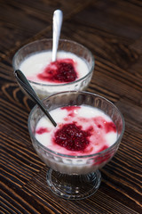 Raspberry yougurt on wooden background
