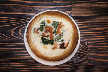 Salmon pie on wooden background