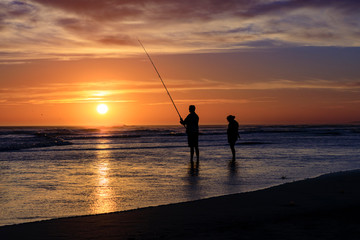 silhouette of fisherman at sunset