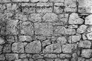 Black and white texture of masonry. Wall of different stone blocks.