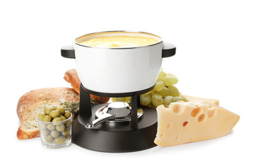 Composition with pot of delicious cheese fondue on white background