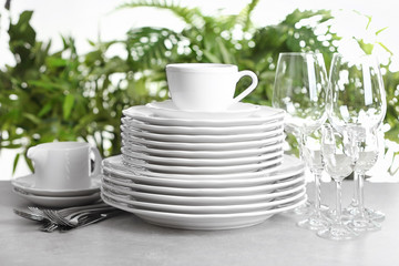 Set of clean dishes on blurred background