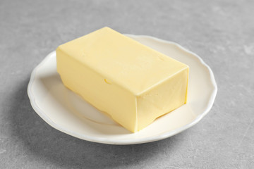 White plate with fresh butter on table