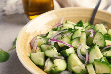 Plate with tasty cucumber salad on table, closeup