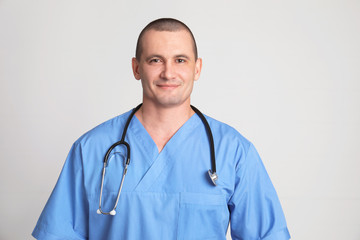 Fototapeta premium Portrait of medical assistant with stethoscope on color background