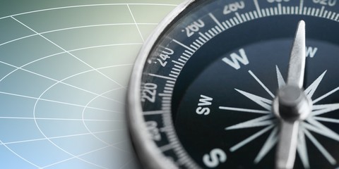 Fototapeta premium Brass antique compass on blue background. Close-up compass.