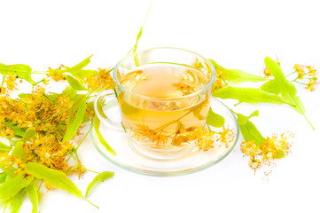 Tea from Linden flowers in glass cup with flower clusters of lim