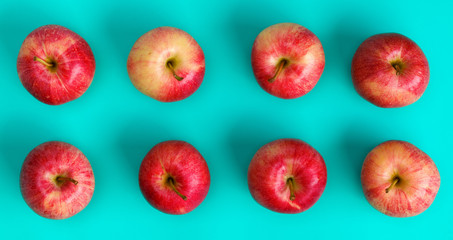 Fruit pattern of red apple on blue background. Flat lay, top view. Pop art design, creative summer concept. Food background.