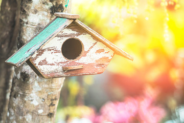 Old wooden house for bird decoration in the garden.