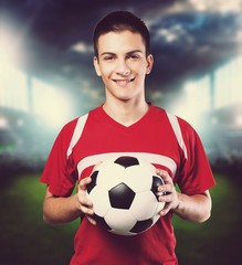 Man hand holding football ball on background