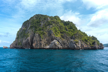 Scenic view of island amidst sea against cloudy sky