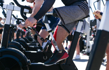 Low section of adaptive athlete exercising on exercise bike