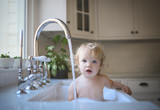 Portrait of girl bathing in sink at home