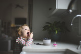 Girl eating blueberries at home
