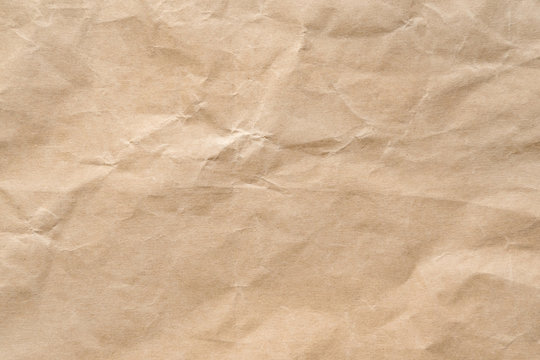Brown wrinkle recycle paper background. Craft paper texture be crumpled and creased.