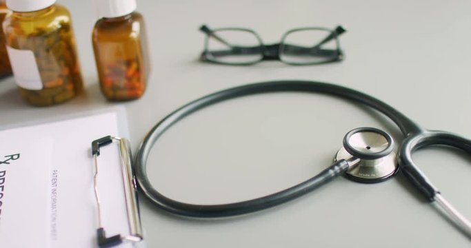 Female Doctor Writing RX Prescription While Holding Pill Bottle 4K