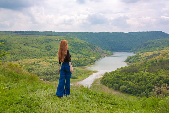 A beautiful girl tourist enjoys nature next to a mountain river Ternava