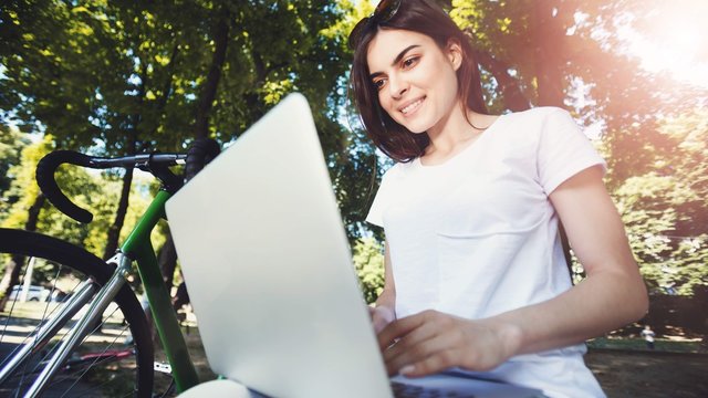 Girl Working With Laptop On Beanch