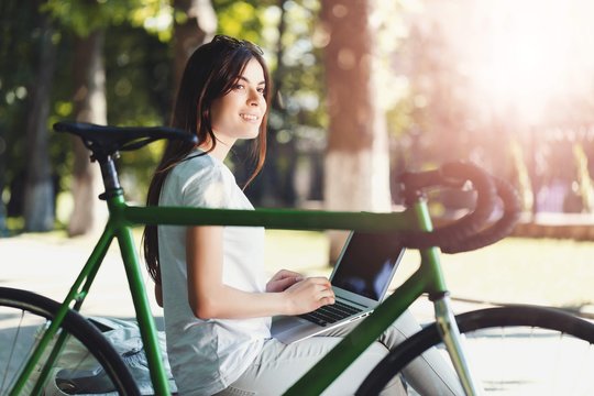 Girl Working With Laptop On Beanch