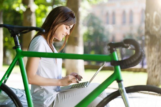 Girl Working With Laptop On Beanch